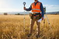 Surveyor wearing professional tool belt with 6 pouches in a field