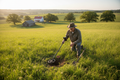 Property owner using metal detector to find buried boundary marker in grassy field